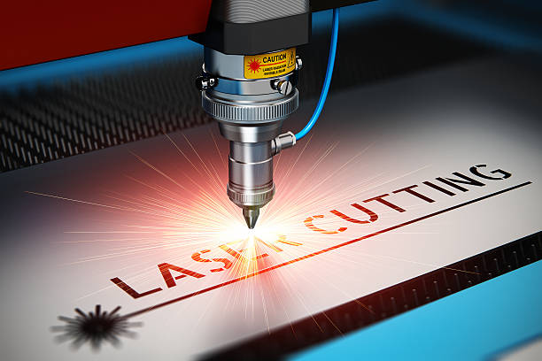 Laser cutting metal industry concept: macro view of industrial digital CNC - computer numerical control CO2 invisible laser beam cutter machine cutting stainless steel sheet with lot of bright shiny sparkles. See also: