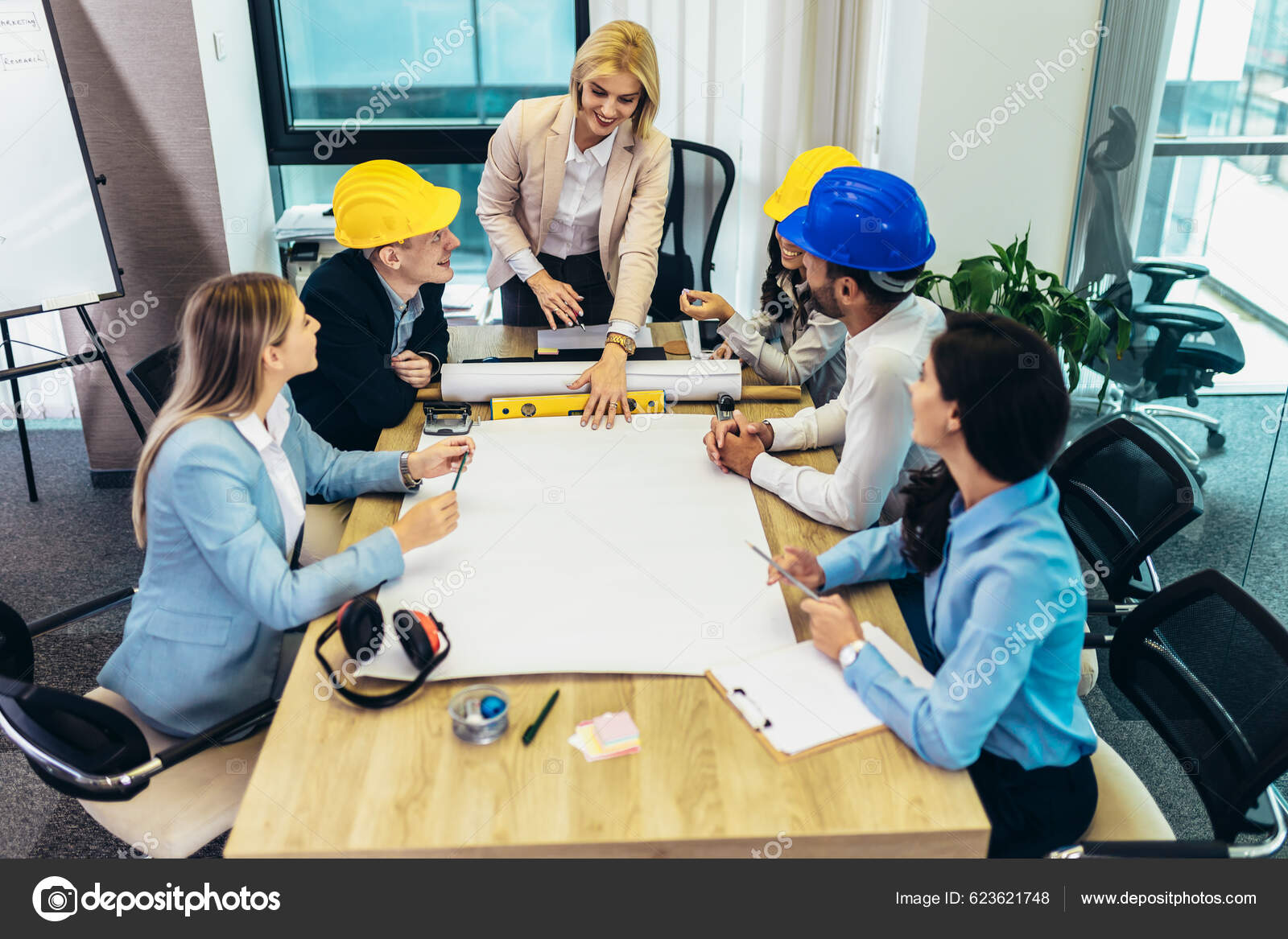 Architects, designers and engineers having working meeting in modern office